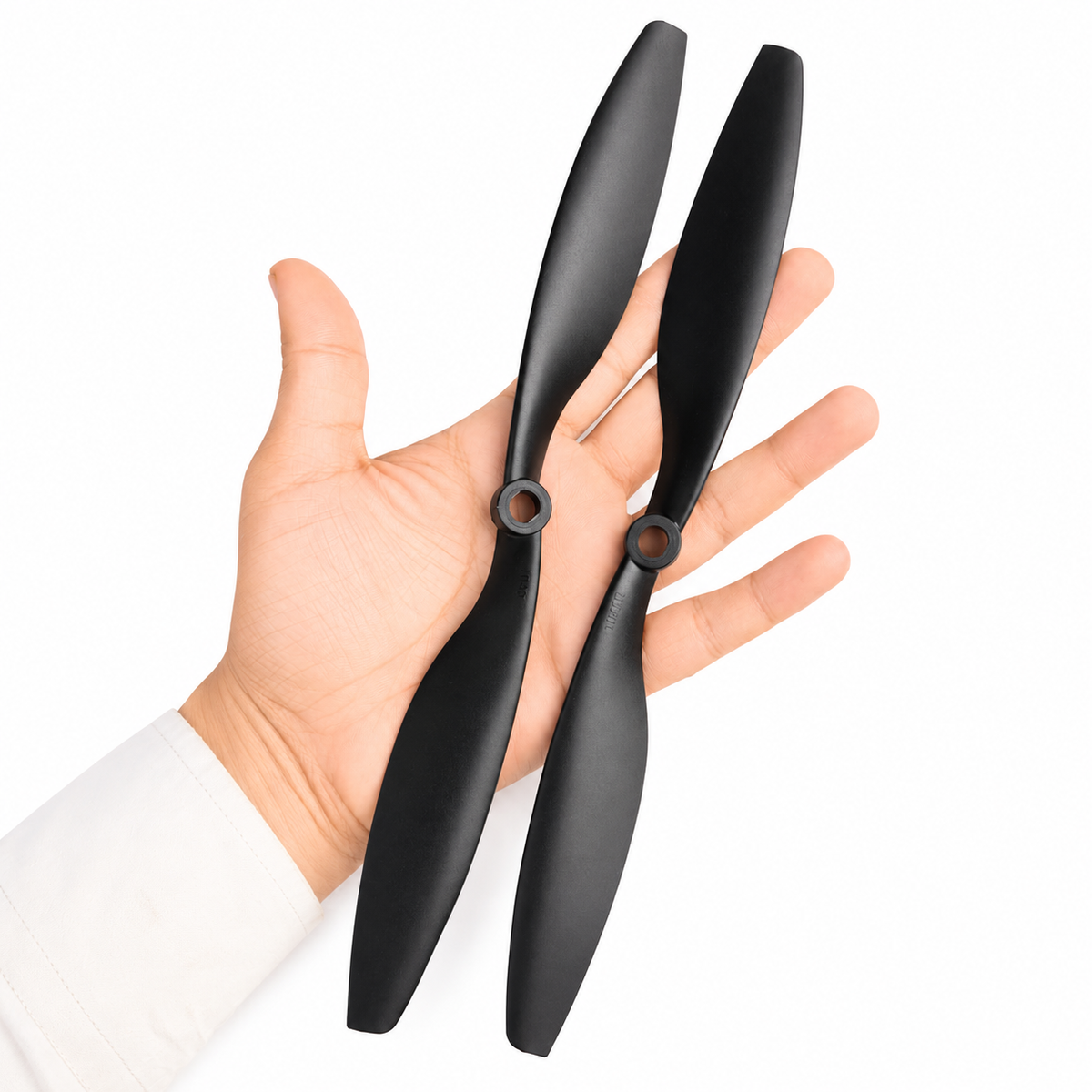 1045 DJI ABS Black Propeller pair shown in hand