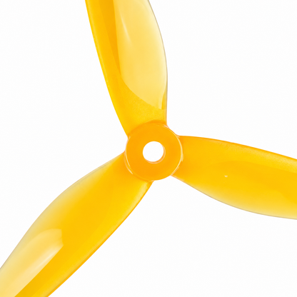 Close-up of 5129 YUKI Yellow PC 3 Blade Drone Propeller showing center hub and aerodynamic blade design