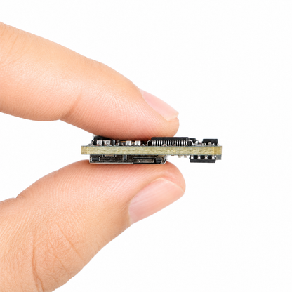 Compact RunCam Mini FPV DVR module held between fingers