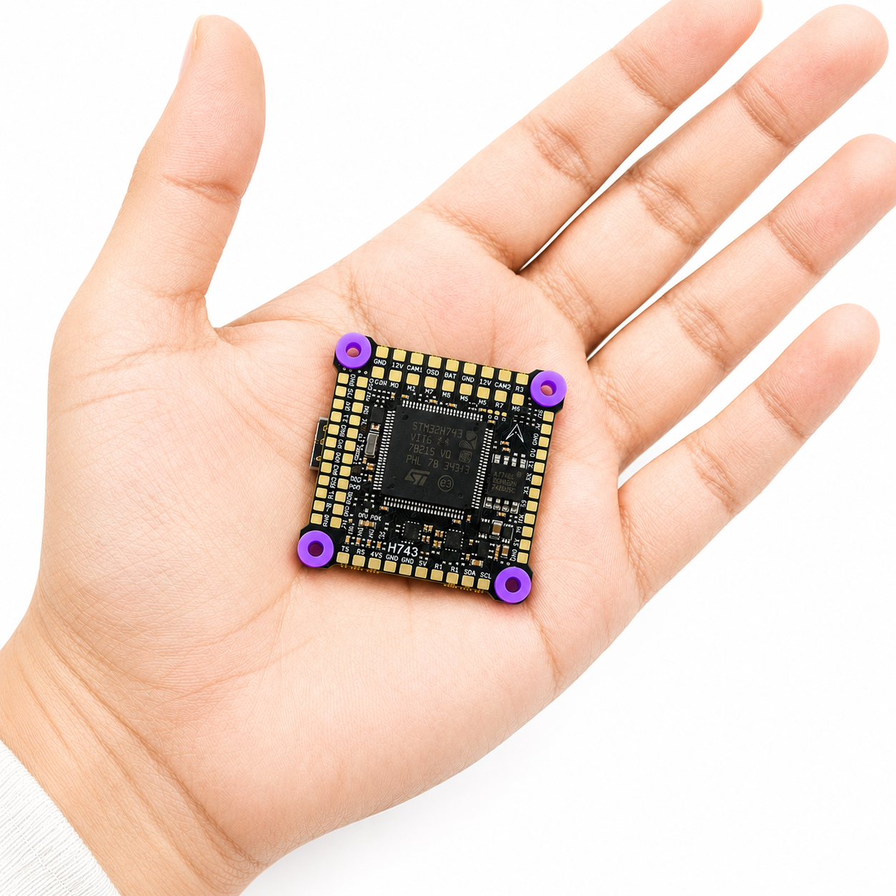 DakeFPV H743 flight controller size comparison in hand