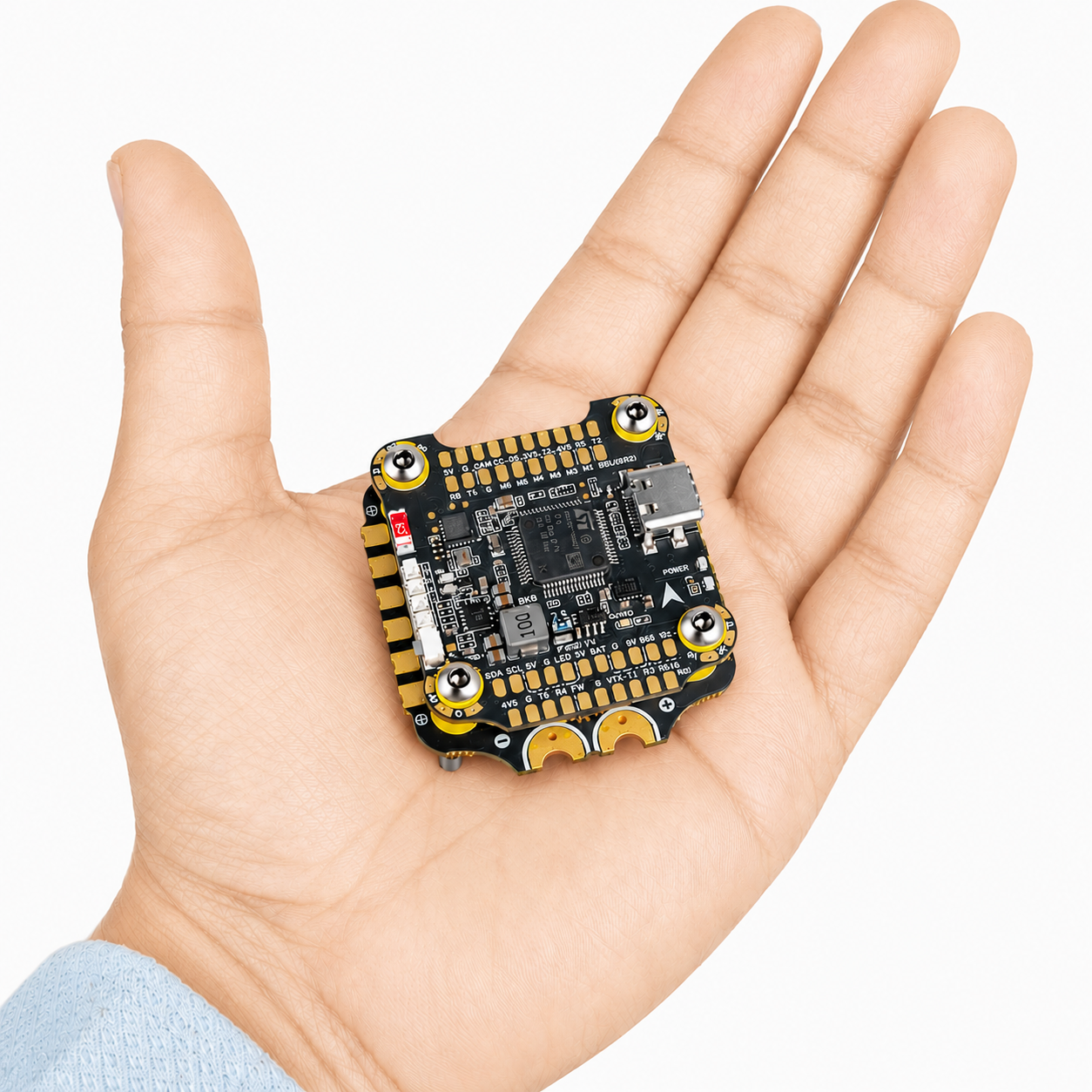 F405 V4 BLS 60A FC ESC stack shown in hand for size comparison
