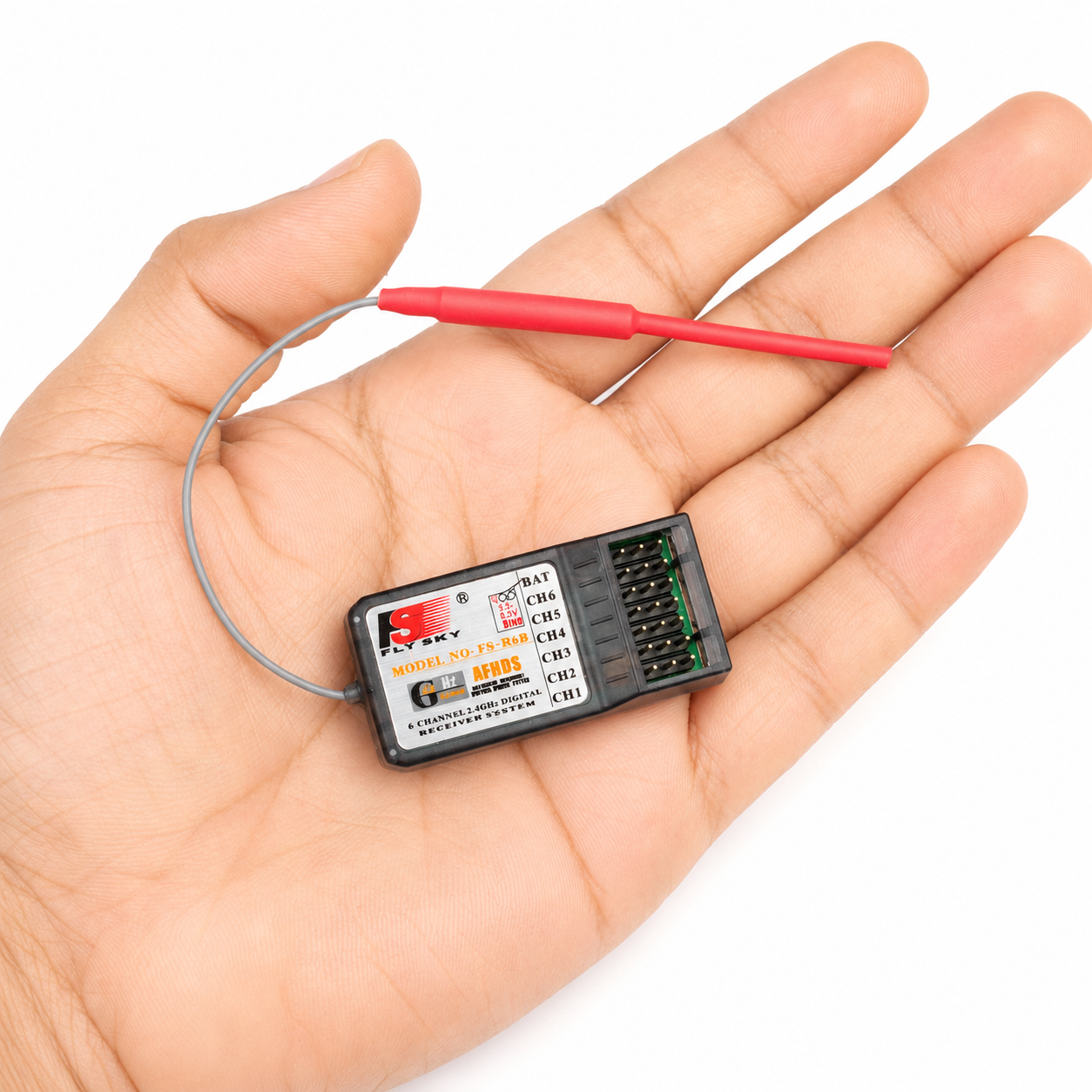 FlySky FS-R6B receiver shown in hand for size reference