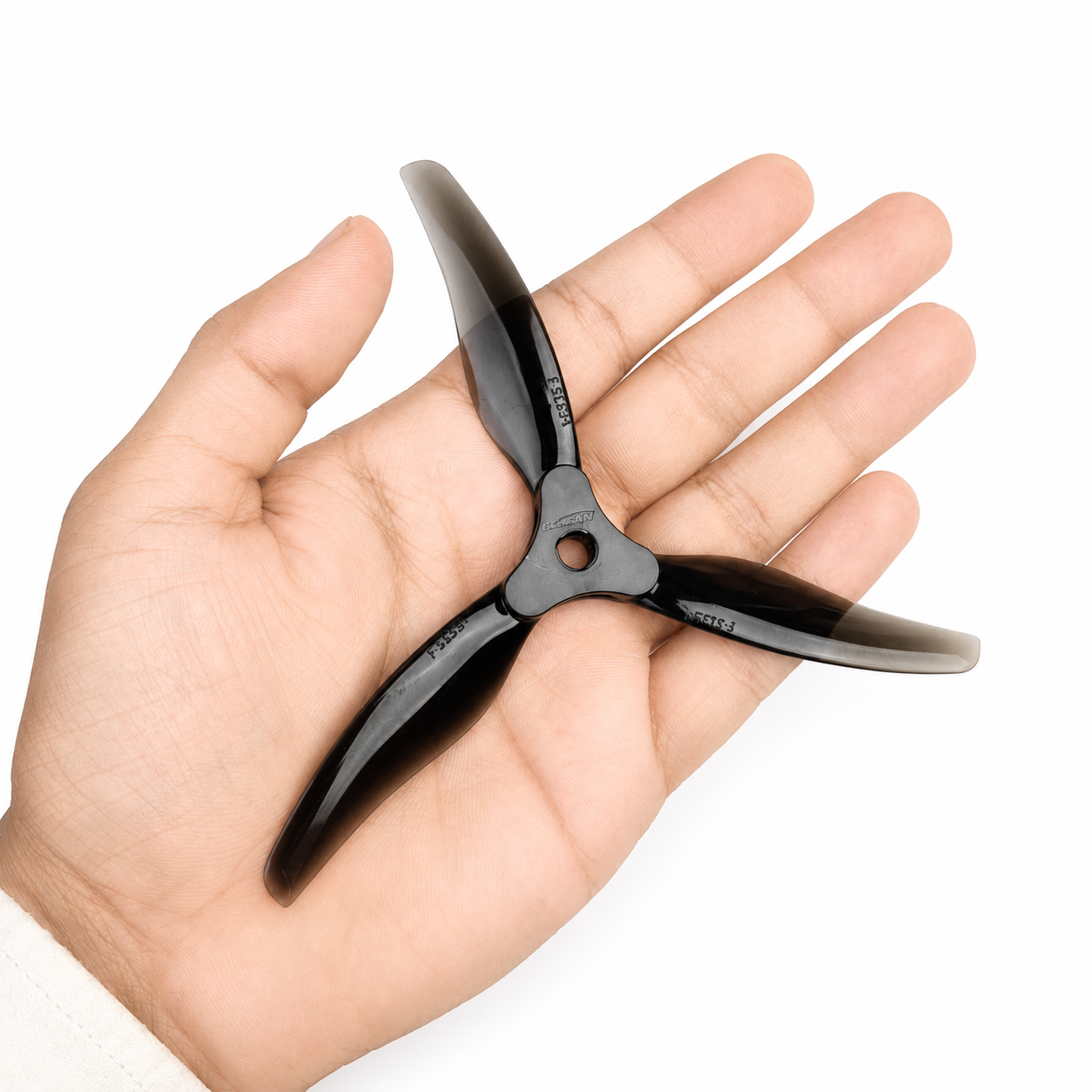 Gemfan F5135 Clear Grey 3 Blade Propeller Held in Hand