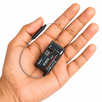 Radiolink R9DS receiver shown in hand for size comparison