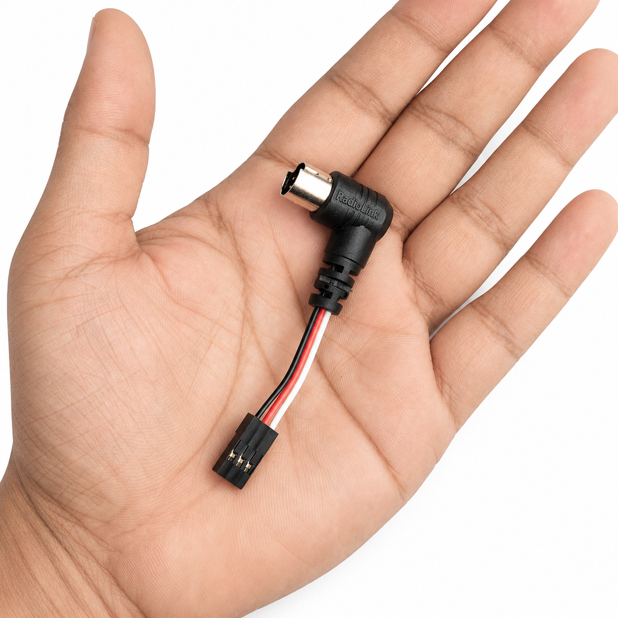 Radiolink wireless trainer system shown in hand for size comparison