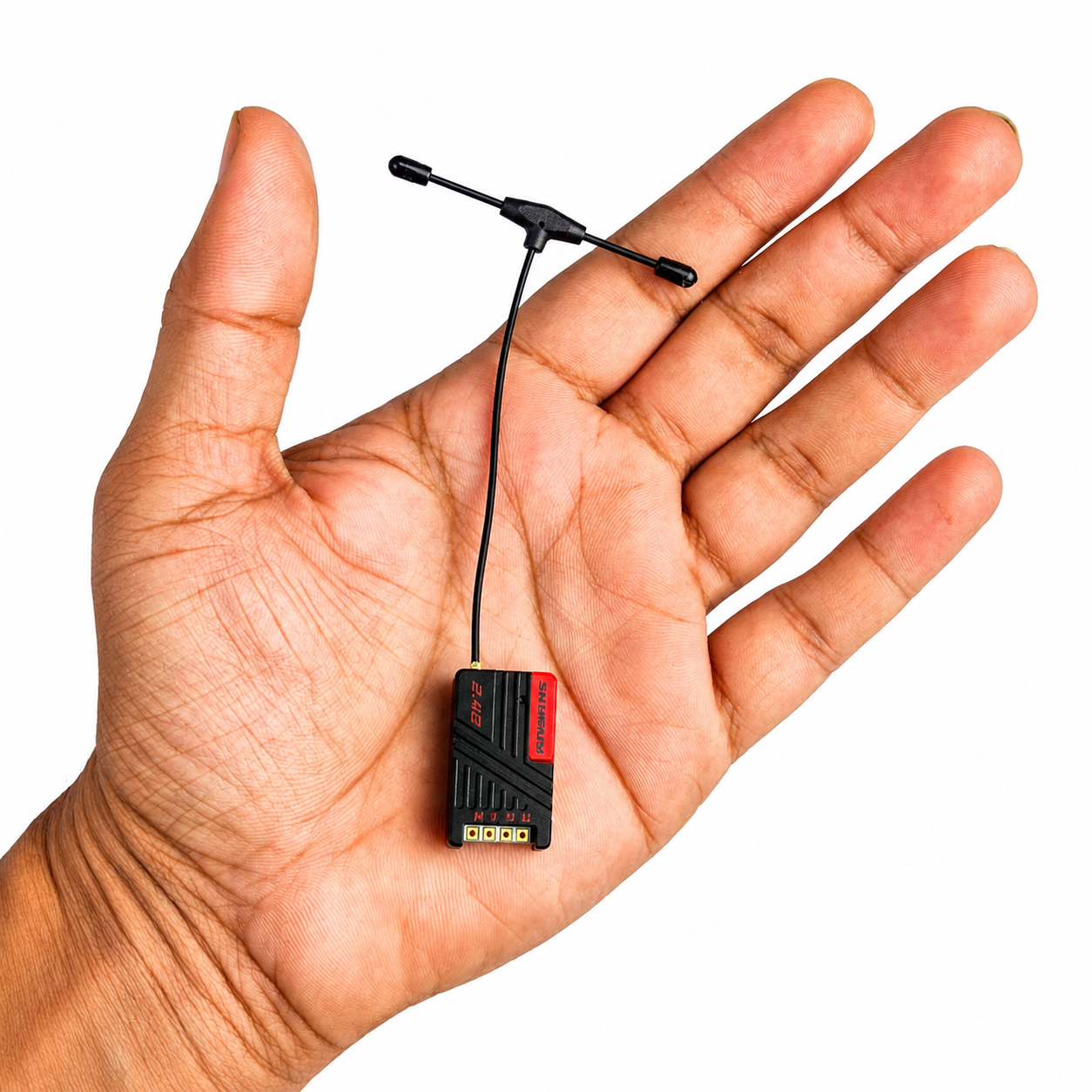 SkyGuy Max ELRS receiver shown in hand for size comparison