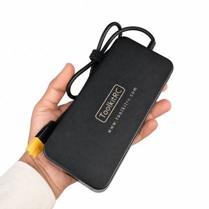 ToolkitRC ADP200 power supply shown in hand